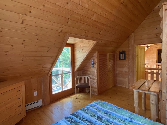 378 Black Point Rd, Beaver Cove, ME 04441 - bedroom featuring vaulted ceiling, a baseboard heating unit, wood walls, wooden ceiling, and light wood finished floors