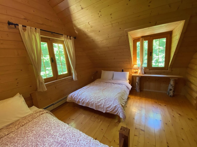 378 Black Point Rd, Beaver Cove, ME 04441 - bedroom featuring baseboard heating, light wood-style floors, lofted ceiling, wooden ceiling, and wooden walls