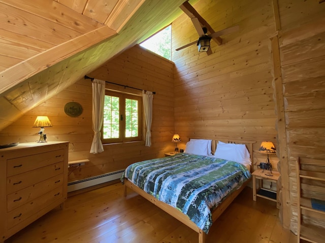 378 Black Point Rd, Beaver Cove, ME 04441 - bedroom featuring a baseboard heating unit, wood walls, lofted ceiling, hardwood / wood-style floors, and wooden ceiling