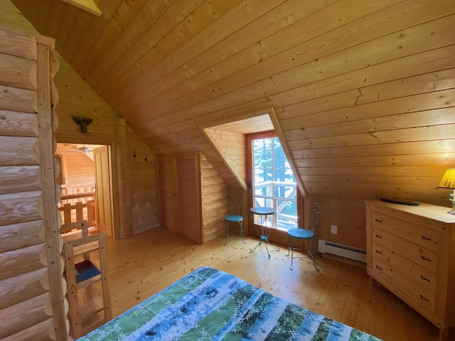 378 Black Point Rd, Beaver Cove, ME 04441 - unfurnished bedroom featuring vaulted ceiling, baseboard heating, light wood-type flooring, wood ceiling, and wooden walls