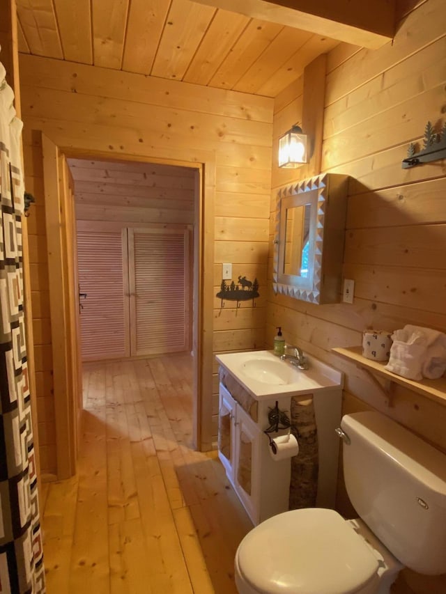 378 Black Point Rd, Beaver Cove, ME 04441 - bathroom with wood walls, hardwood / wood-style floors, wood ceiling, vanity, and a shower with shower curtain