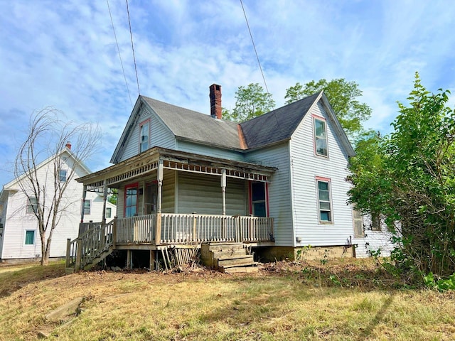363 Lisbon St, Lisbon, ME 04250 - view of front facade with covered porch and a chimney