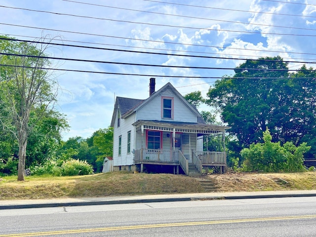 363 Lisbon St, Lisbon, ME 04250 - victorian-style house featuring covered porch and a chimney