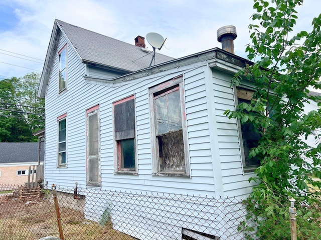 363 Lisbon St, Lisbon, ME 04250 - view of side of property featuring roof with shingles and a chimney