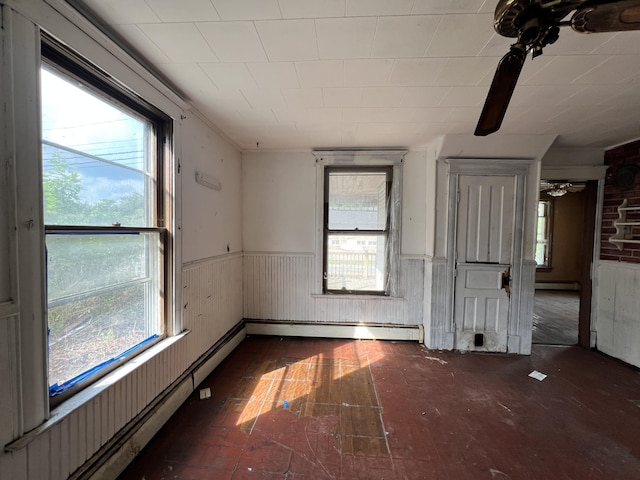 363 Lisbon St, Lisbon, ME 04250 - spare room with plenty of natural light, wainscoting, a ceiling fan, baseboard heating, and wood walls