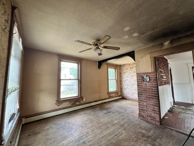363 Lisbon St, Lisbon, ME 04250 - unfurnished room with wood-type flooring, a baseboard radiator, ceiling fan, and a textured ceiling