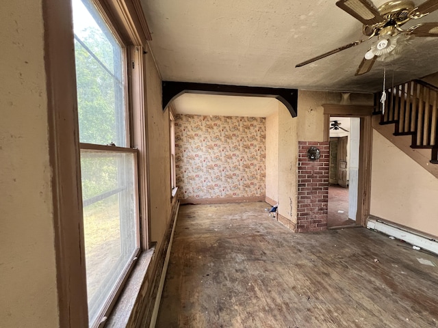 363 Lisbon St, Lisbon, ME 04250 - unfurnished living room with a ceiling fan, healthy amount of natural light, stairway, and arched walkways