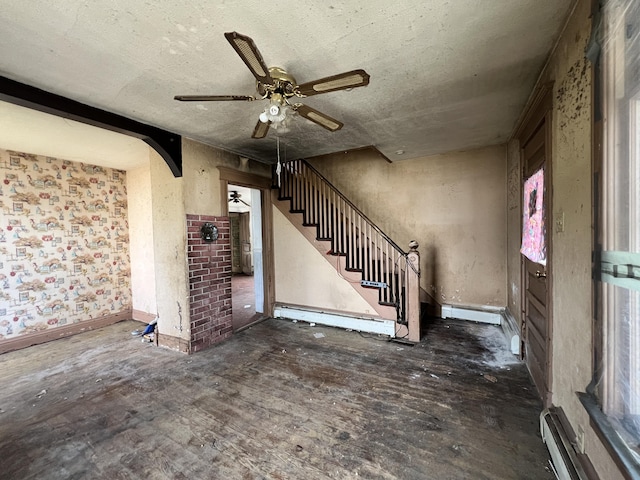 363 Lisbon St, Lisbon, ME 04250 - foyer entrance featuring a ceiling fan, arched walkways, stairway, a baseboard heating unit, and a baseboard radiator