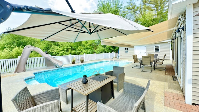 8 Clark Cir, Hampden, ME 04444 - view of pool with outdoor dining space, a water slide, a patio area, and an outdoor structure