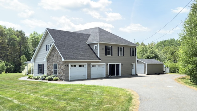 8 Clark Cir, Hampden, ME 04444 - view of front of house with asphalt driveway, roof with shingles, a front lawn, and stone siding
