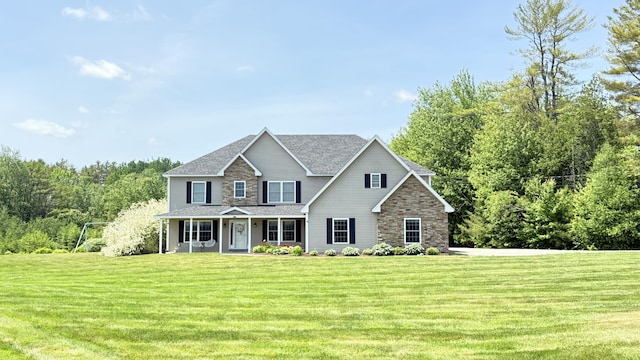 8 Clark Cir, Hampden, ME 04444 - view of front of house with stone siding, a porch, a front lawn, and a shingled roof