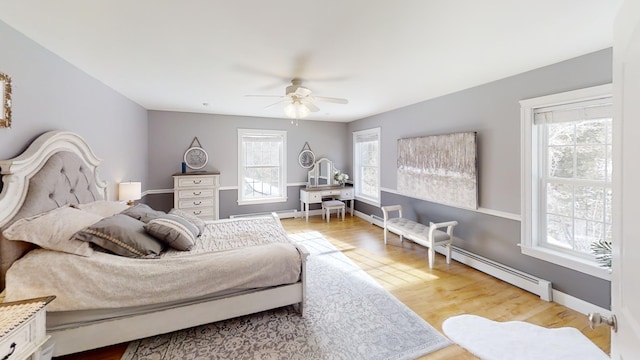 8 Clark Cir, Hampden, ME 04444 - bedroom with wood finished floors, ceiling fan, and a baseboard radiator