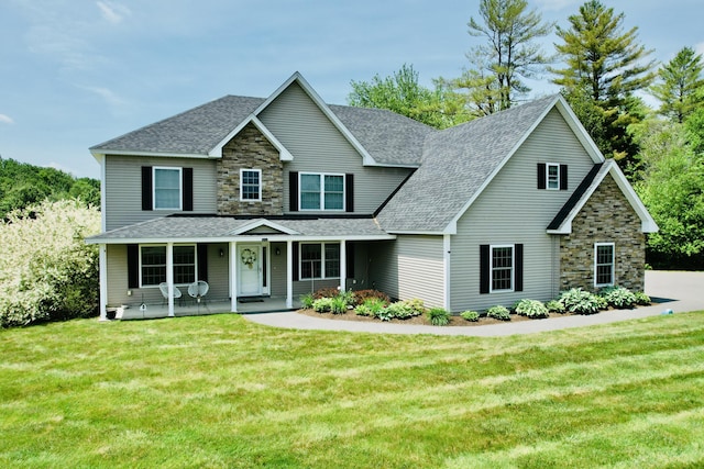 8 Clark Cir, Hampden, ME 04444 - view of front of property with stone siding, roof with shingles, a front yard, and covered porch