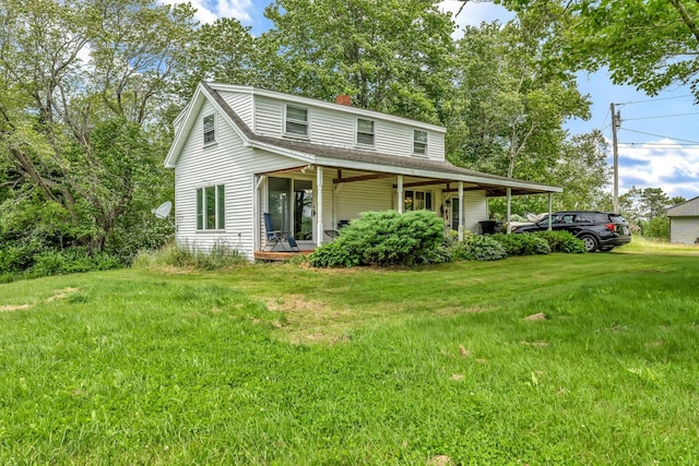 350 Cushing Rd, Cushing, ME 04563 - view of front facade with a porch, a chimney, a front yard, and roof with shingles