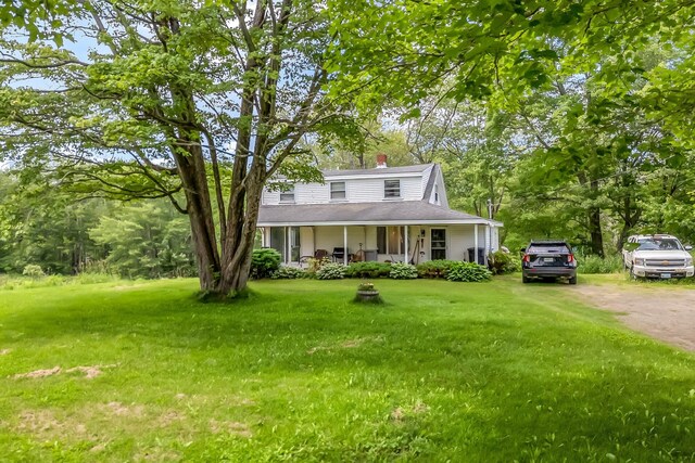 350 Cushing Rd, Cushing, ME 04563 - view of front facade featuring a porch, a front yard, and a chimney