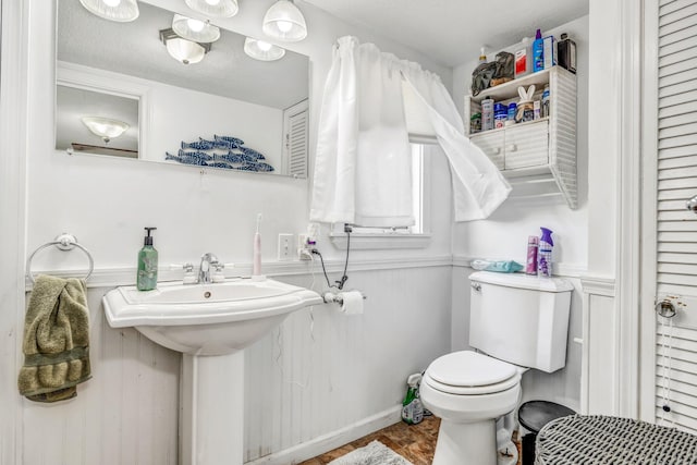 350 Cushing Rd, Cushing, ME 04563 - bathroom with toilet and a wainscoted wall
