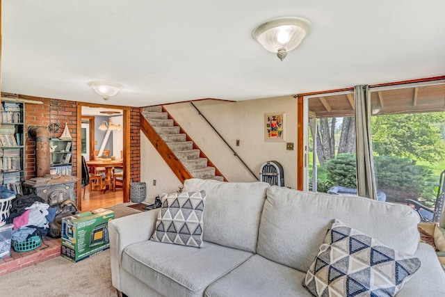 350 Cushing Rd, Cushing, ME 04563 - carpeted living area featuring stairs and a wood stove