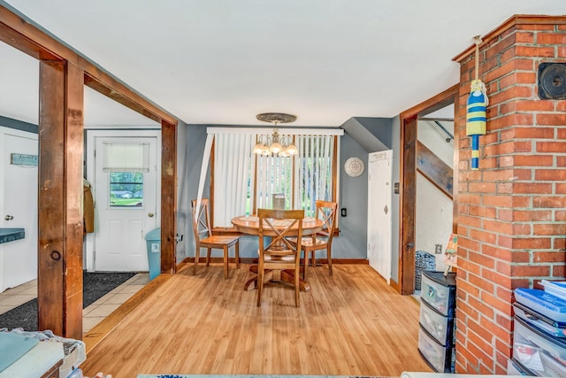 350 Cushing Rd, Cushing, ME 04563 - dining area featuring a chandelier, light wood-type flooring, and a wood stove