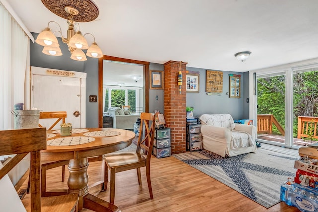 350 Cushing Rd, Cushing, ME 04563 - dining room featuring light wood-style floors and a chandelier
