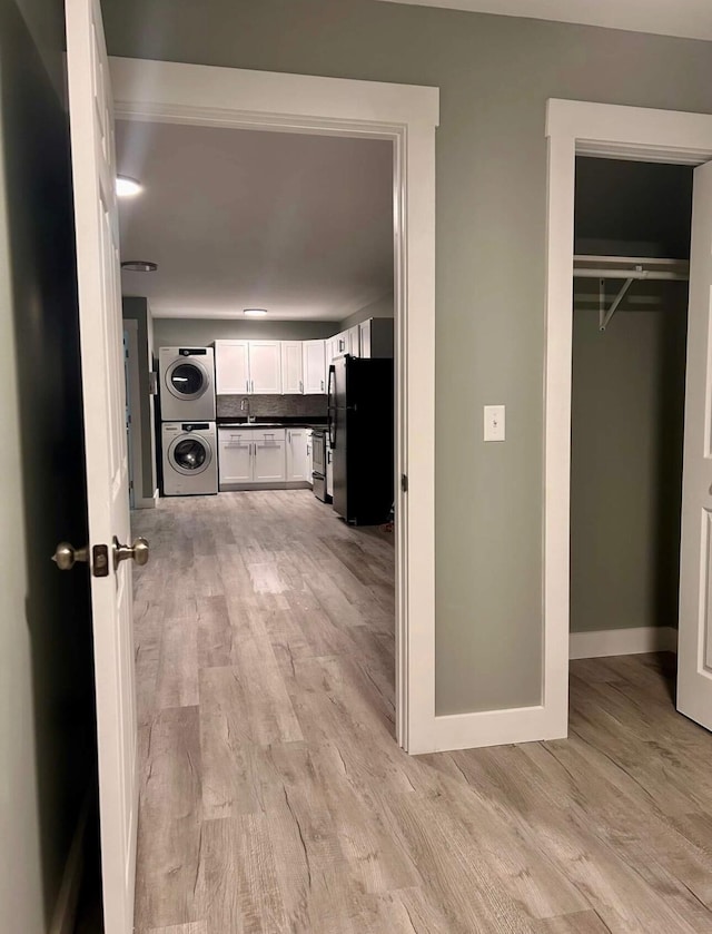 42 Applehead Way, Orrington, ME 04474 - hall featuring stacked washer and clothes dryer and light wood finished floors