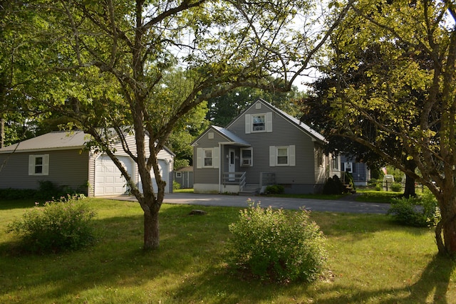 251 E Bridge St, Westbrook, ME 04092 - view of front of property with asphalt driveway, an outdoor structure, a front yard, and an attached garage