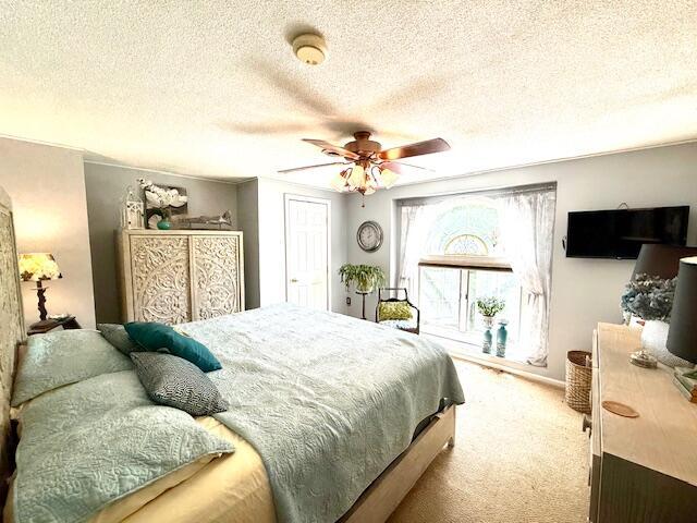 12 Doe Ct Unit 12, Naples, ME 04055 - bedroom with carpet flooring, a textured ceiling, and a ceiling fan