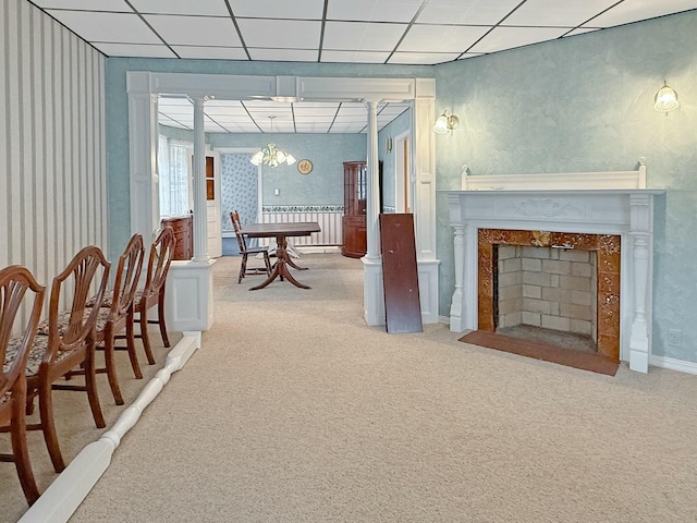 35 Washington St, Rumford, ME 04276 - carpeted dining area with wallpapered walls, a chandelier, and a fireplace with flush hearth