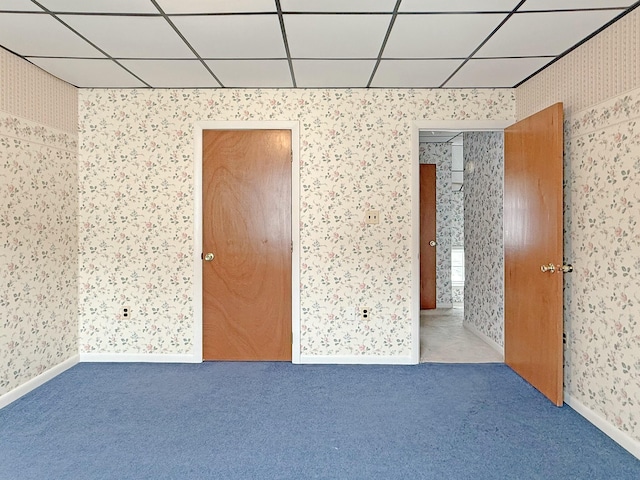35 Washington St, Rumford, ME 04276 - carpeted empty room with wallpapered walls and a paneled ceiling