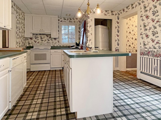 35 Washington St, Rumford, ME 04276 - kitchen featuring wallpapered walls, white appliances, under cabinet range hood, white cabinets, and a paneled ceiling