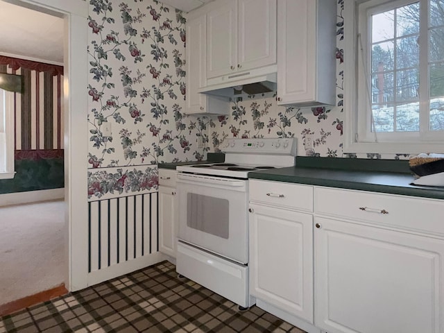 35 Washington St, Rumford, ME 04276 - kitchen featuring wallpapered walls, electric stove, under cabinet range hood, dark countertops, and plenty of natural light