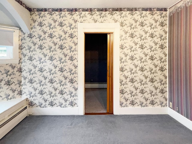 35 Washington St, Rumford, ME 04276 - spare room with a baseboard heating unit, wallpapered walls, carpet floors, and a baseboard radiator
