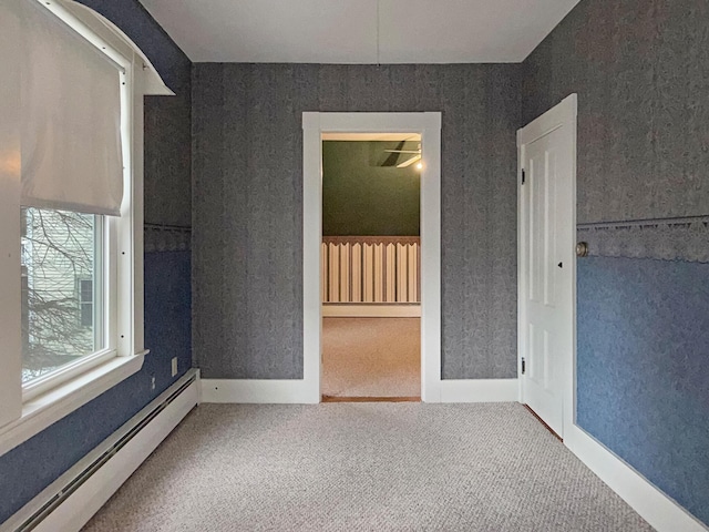 35 Washington St, Rumford, ME 04276 - unfurnished room featuring baseboard heating, carpet floors, a baseboard radiator, and wallpapered walls