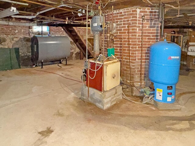 35 Washington St, Rumford, ME 04276 - basement with oil tank, a water pressure tank, and a heating unit