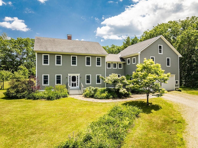 270 Park St, Rockport, ME 04856 - colonial house with a chimney, a front lawn, a garage, dirt driveway, and a shingled roof