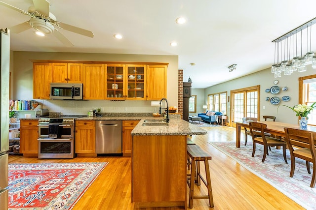 270 Park St, Rockport, ME 04856 - kitchen featuring stainless steel appliances, a ceiling fan, brown cabinets, light wood finished floors, and recessed lighting