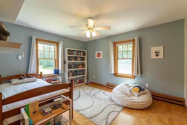 270 Park St, Rockport, ME 04856 - bedroom with multiple windows, wood finished floors, and ceiling fan
