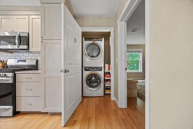 7 Coastal Woods Dr Unit 102, Kennebunk, ME 04043 - laundry room with stacked washer / dryer and light wood-style floors
