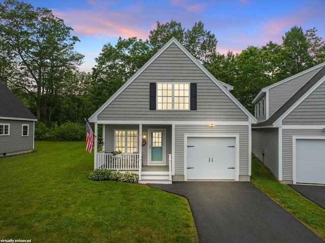 7 Coastal Woods Dr Unit 102, Kennebunk, ME 04043 - view of front of property featuring a porch, a garage, asphalt driveway, and a front lawn