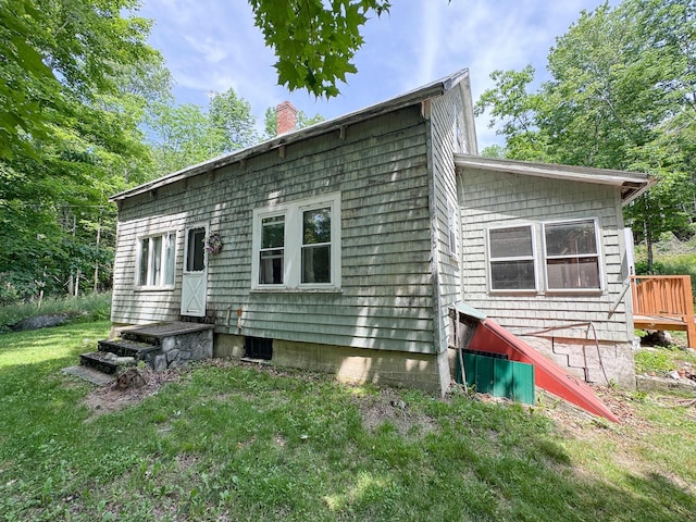 144 Main Rd, Burlington, ME 04417 - back of property with a chimney and a yard