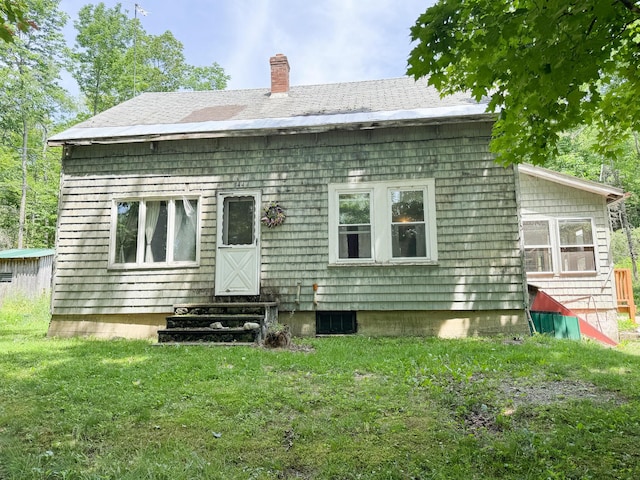 144 Main Rd, Burlington, ME 04417 - rear view of house with entry steps, a chimney, and a yard