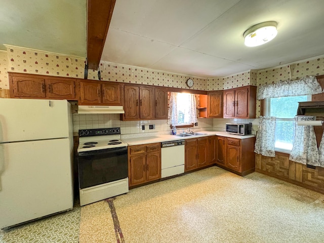 144 Main Rd, Burlington, ME 04417 - kitchen featuring white appliances, under cabinet range hood, light countertops, wallpapered walls, and brown cabinets