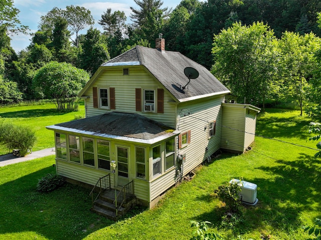 9 Coolidge St, Livermore, ME 04253 - back of property featuring entry steps, a chimney, a shingled roof, and a yard