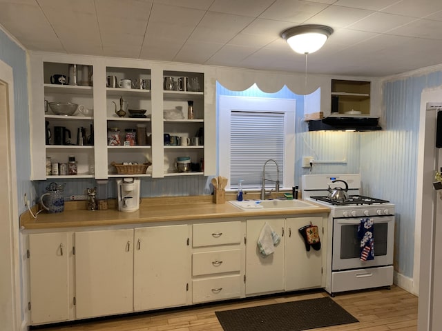 9 Coolidge St, Livermore, ME 04253 - kitchen with white gas range oven, open shelves, light wood-style flooring, light countertops, and extractor fan