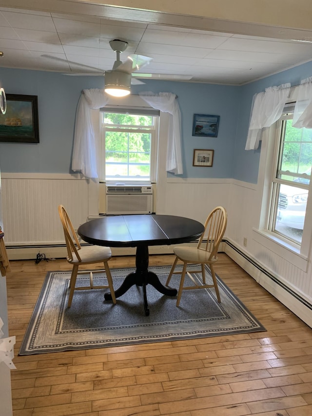 9 Coolidge St, Livermore, ME 04253 - dining room with wainscoting, healthy amount of natural light, cooling unit, and wood finished floors