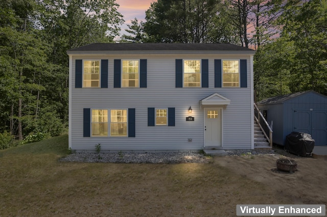 152 Quarry Rd, Limerick, ME 04048 - colonial inspired home with a fire pit, a shed, a front yard, a chimney, and stairs