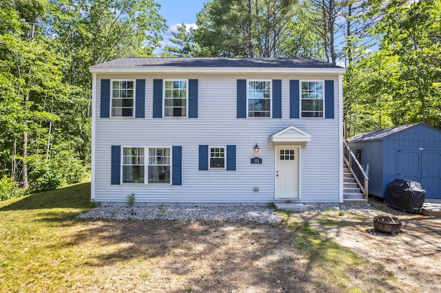 152 Quarry Rd, Limerick, ME 04048 - colonial-style house with an outdoor fire pit, a storage unit, and a front lawn