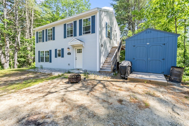 152 Quarry Rd, Limerick, ME 04048 - colonial inspired home with a fire pit, stairway, and a shed