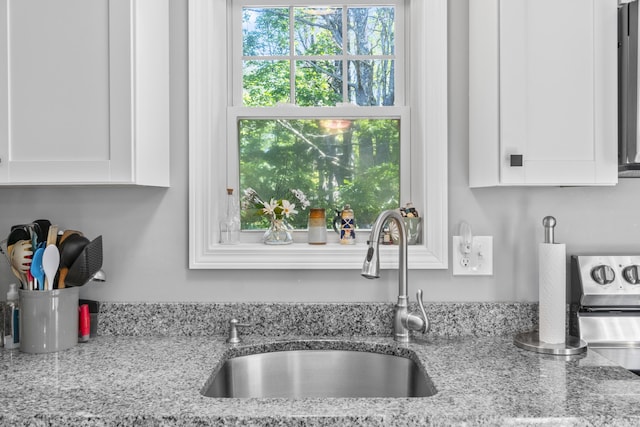 152 Quarry Rd, Limerick, ME 04048 - kitchen view of white cabinets, light stone counters, and electric stove