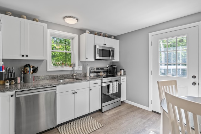 152 Quarry Rd, Limerick, ME 04048 - kitchen with appliances with stainless steel finishes, plenty of natural light, dark stone counters, and light wood finished floors