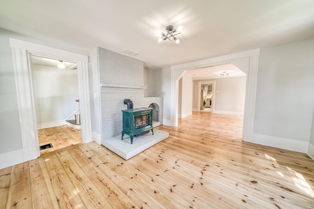 47 Main Rd N, Hampden, ME 04444 - unfurnished living room featuring a wood stove and hardwood / wood-style flooring